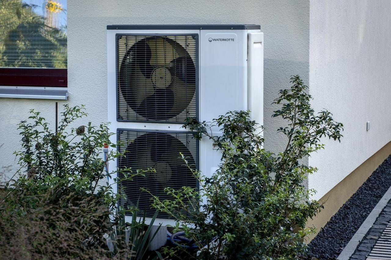 More than 12,000 Canadians have applied for federal grants to help offset the cost of replacing oil furnaces with electric heat pumps. A heat pump is installed at a house in Frankfurt, Germany, Thursday, Sept. 7, 2023. THE CANADIAN PRESS/AP-Michael Probst