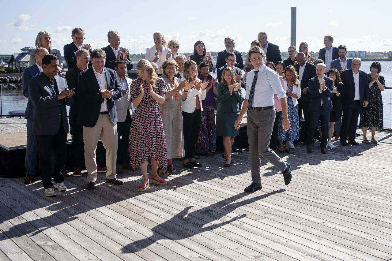 Prime Minister Justin Trudeau walks past members of his cabinet after speaking to reporters during the Liberal Cabinet retreat in Charlottetown, P.E.I. on Wednesday, August 23, 2023. The federal cabinet will hear from a range of experts on housing, economics and Canada-U.S. relations over three days of meetings in Montreal next week.THE CANADIAN PRESS/Darren Calabrese