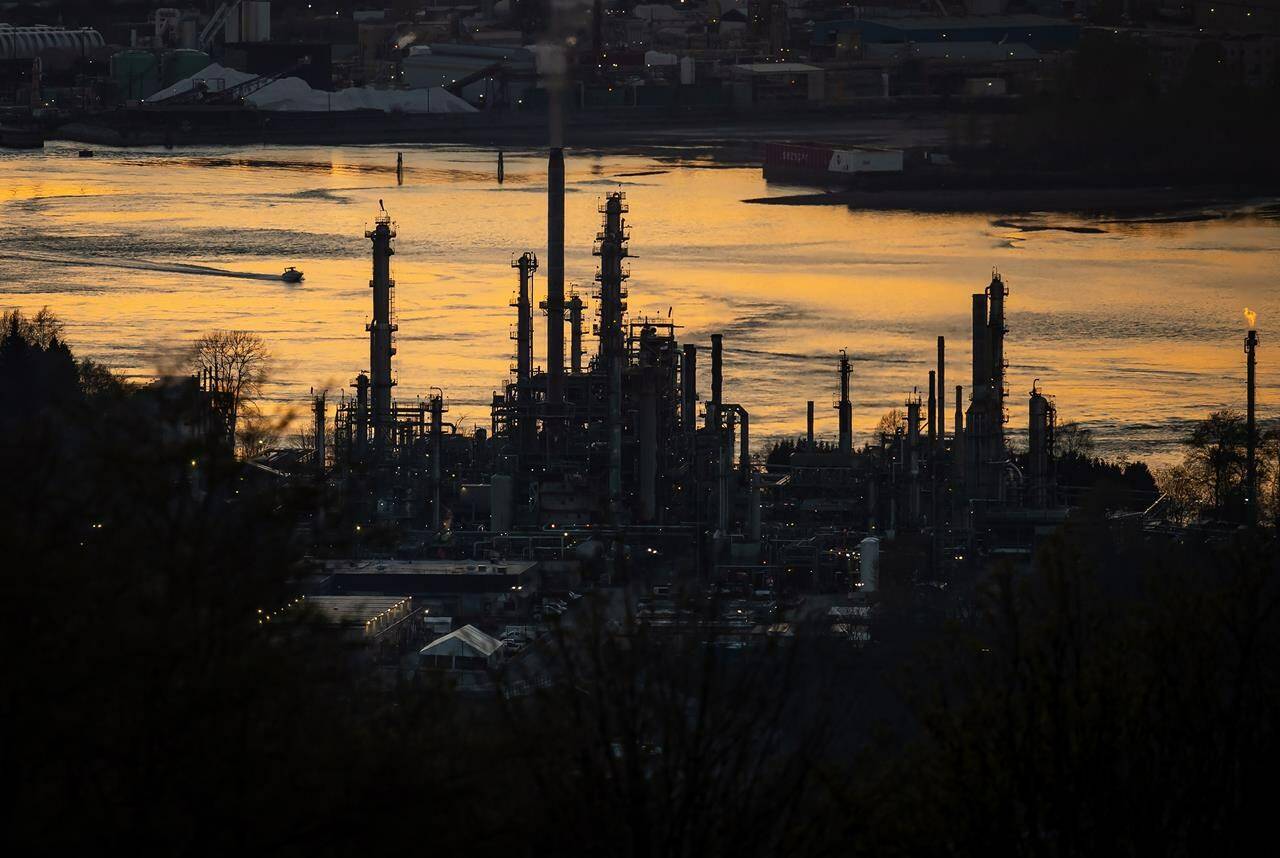 A boat travels past the Parkland Burnaby Refinery on Burrard Inlet at sunset in Burnaby, B.C., on Saturday, April 17, 2021. THE CANADIAN PRESS/Darryl Dyck