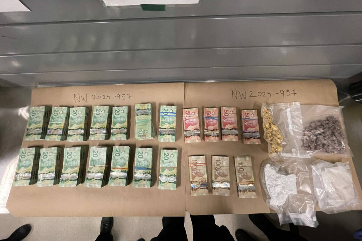 A driver and passenger were arrested in New Westminster after police found $110,000 worth of cash and another $100,000 worth drugs in vacuum-sealed packages in the vehicle during a traffic stop on Jan. 18, 2024. (New Westminster Police handout)