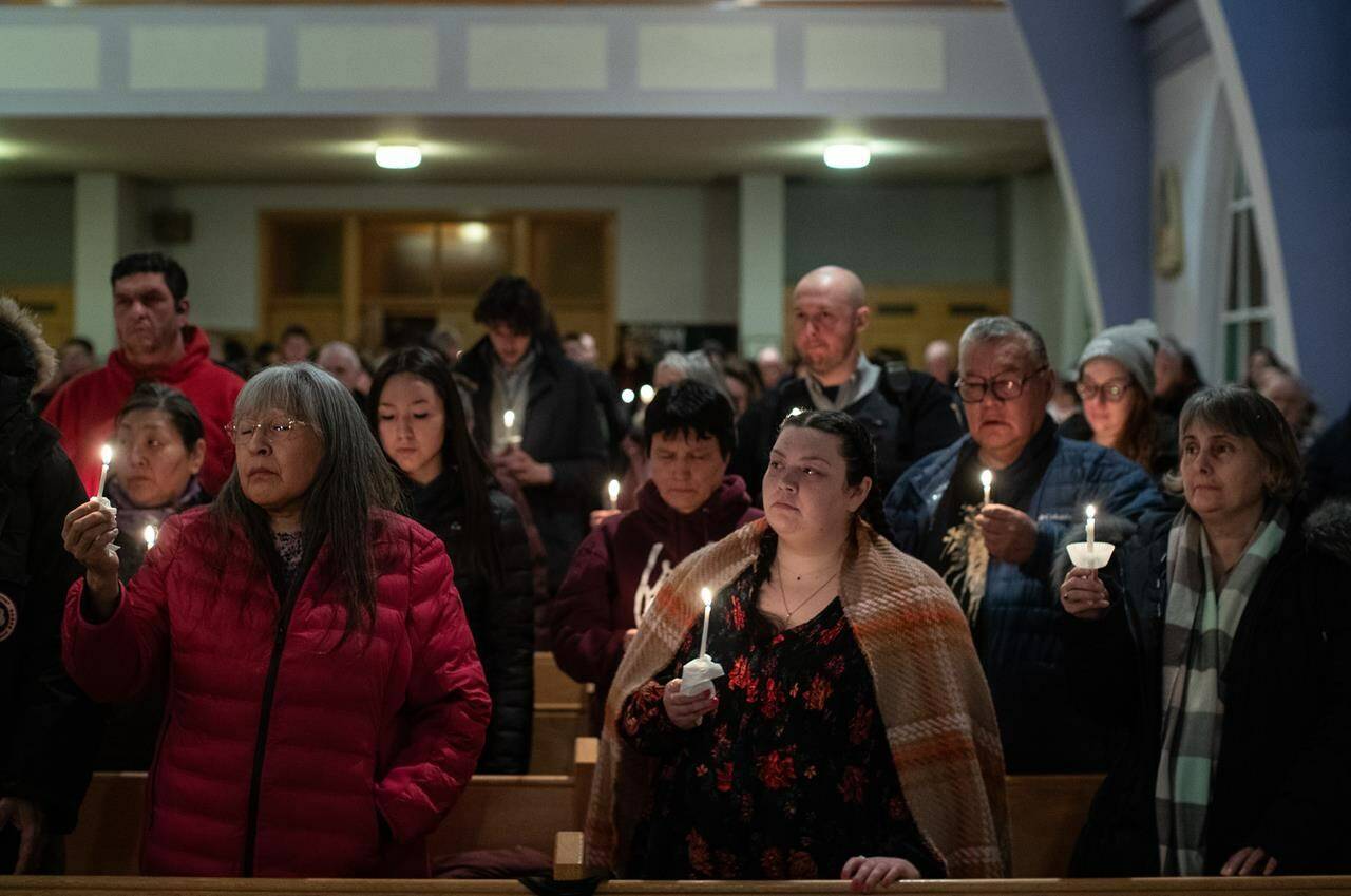 Community members gather and hold a vigil for the six people killed in a plane crash, in Fort Smith, Northwest Territories, on Wednesday, January 24, 2024.THE CANADIAN PRESS/Jason Franson