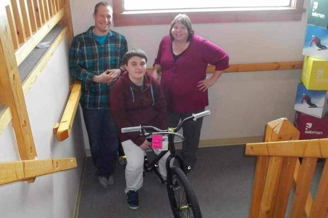 Ten years ago, Aileen Ingram raised money for a local boy so he could replace his stolen bike, a single act of goodwill that turned into a kindness-fuelled movement and touched all areas of the East Kootenays. Ingram, right, stands with bike-owner Kobe and owner of Gerick Sports Mike Stephen (photo courtesy of Aileen Ingram)