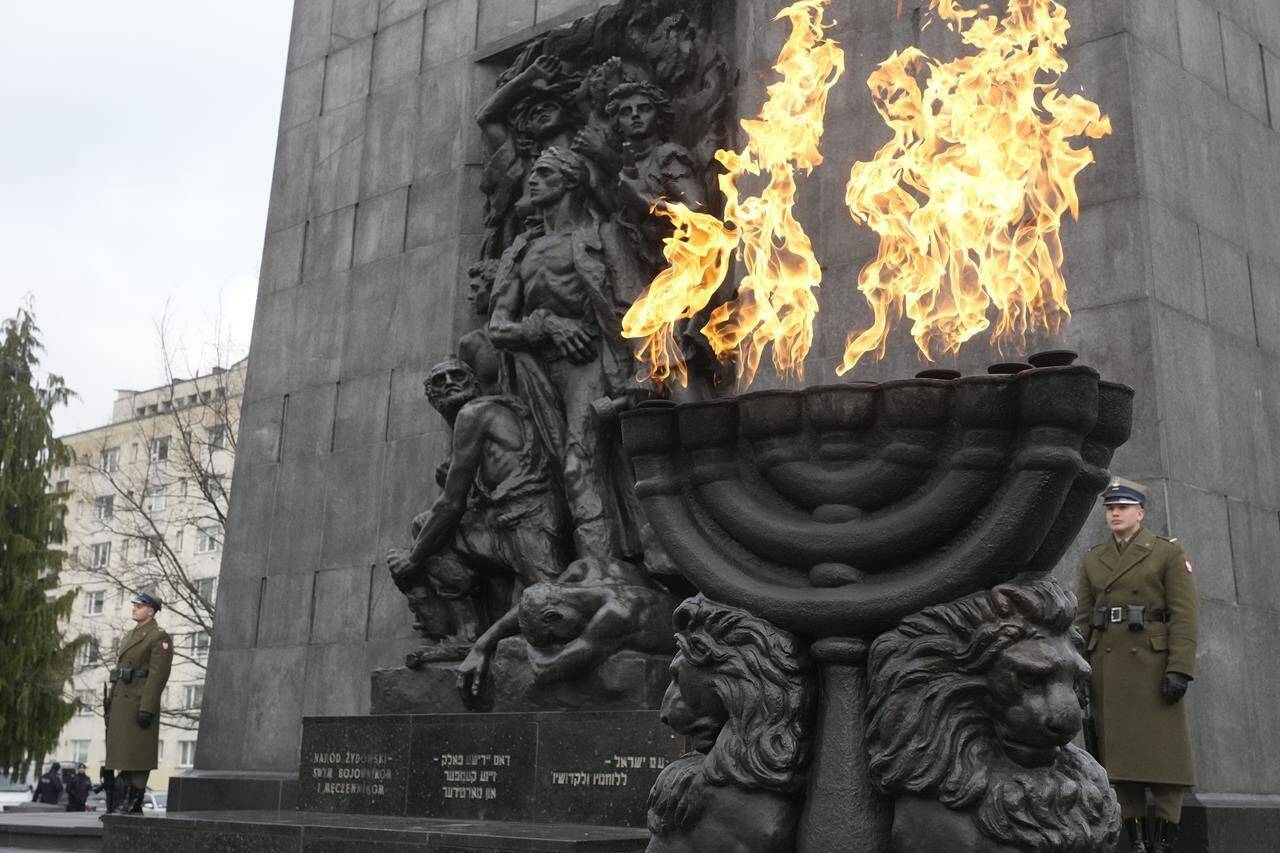 Fire burns in a giant menorah during ceremonies on the eve of the 79th anniversary of the liberation of the Nazi German death camp of Auschwitz-Birkenau by Soviet troops, at the Monument to the Heroes of the Ghetto, in Warsaw, Poland, on Friday, Jan.26, 2024. Main ceremonies with the participation of a handful of survivors are to take place at the Auschwitz-Birkenau memorial place on Saturday, Jan. 27, which is also the International Holocaust Remembrance Day. (AP Photo/Czarek Sokolowski)