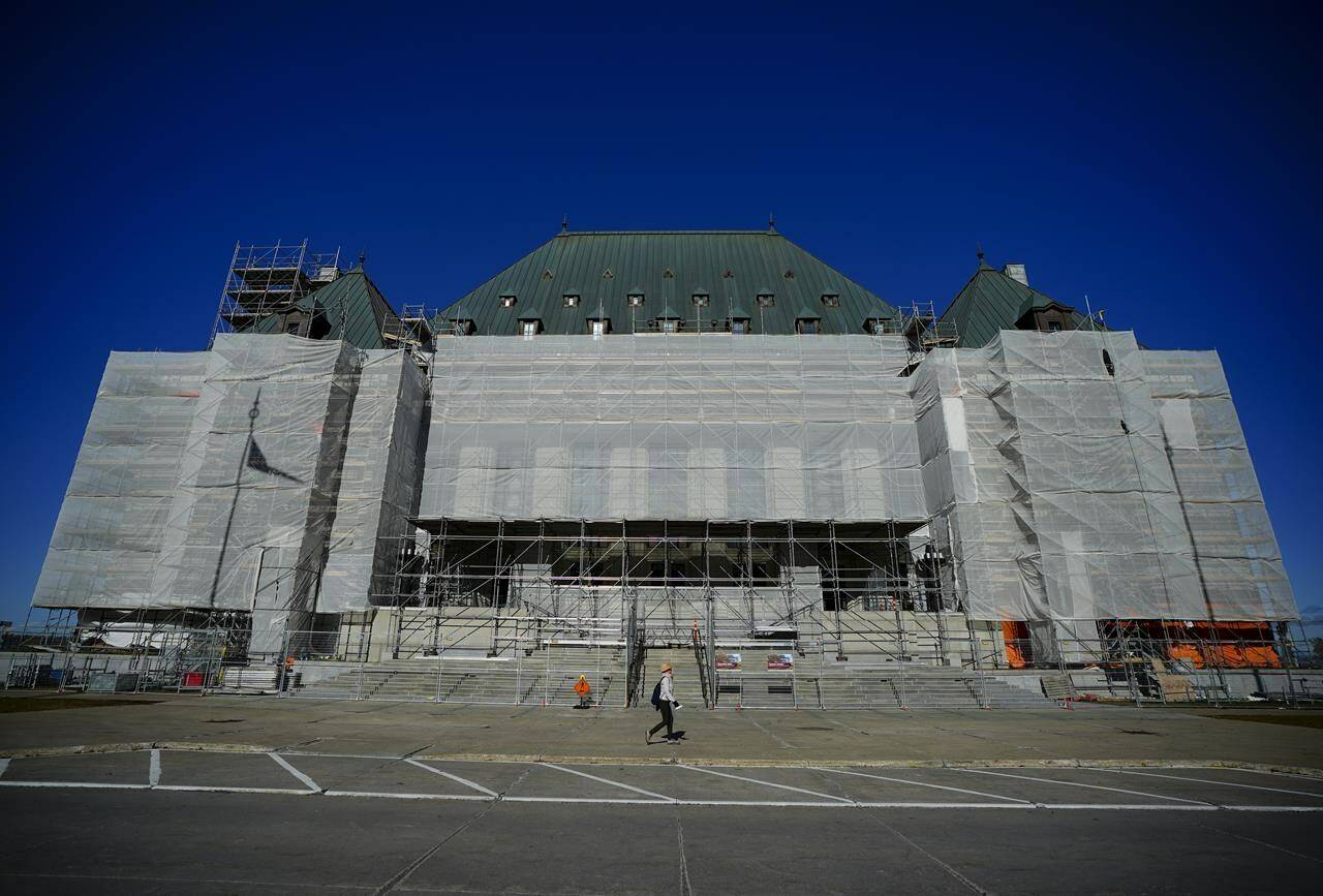 The Supreme Court of Canada says several people arrested for drug-related offences must face a new trial because a judge improperly stayed the charges against them. A person walks past the Supreme Court of Canada during construction in Ottawa on Monday, Oct. 23, 2023. THE CANADIAN PRESS/Sean Kilpatrick