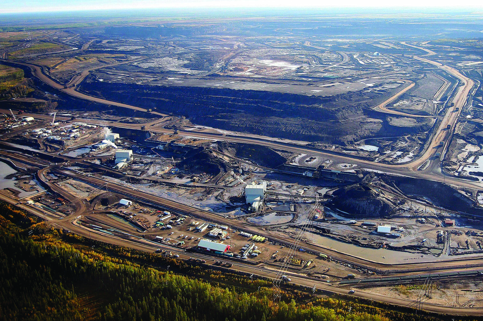 This Sept. 19, 2011 aerial photo shows a tar sands mine facility near Fort McMurray, in Alberta. A new wave of cold water is about to hit Canada’s much-buffeted oilsands industry but whether the storm will be perfect or another tempest in a teapot is yet to be determined. THE CANADIAN PRESS/Jeff McIntosh