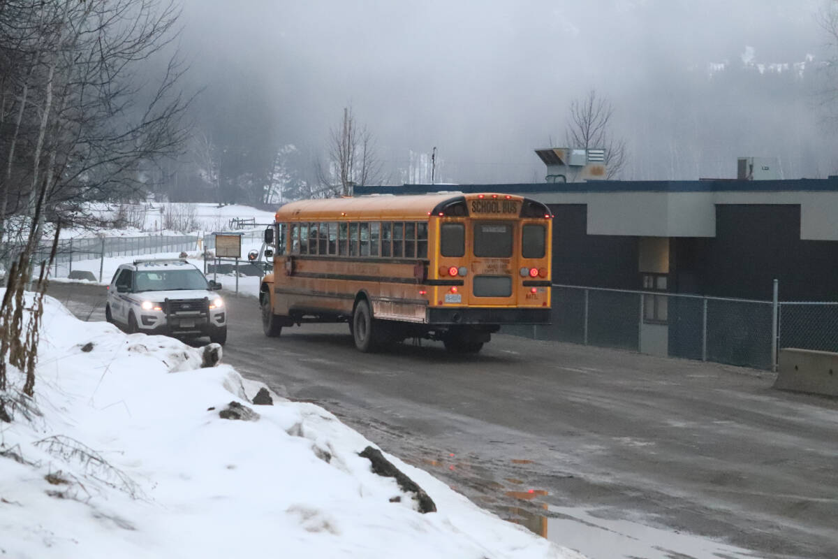 A school bus and RCMP cruiser meet at the back drop off area at Raft River Elementary School on Monday, Jan. 29 during a hold and secure order, which is in effect at both schools in Clearwater. (Photo by: Zephram Tino)
