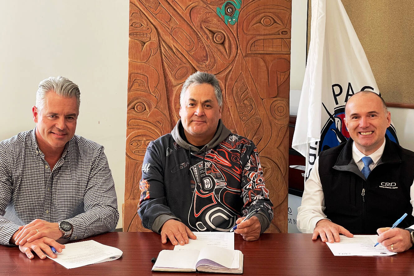 CRD chief administrative officer Ted Robbins, left, Pacheedaht First Nation Chief Jeff Jones and CRD board chair Colin Plant sign a memorandum of understanding. (Contributed – CRD)