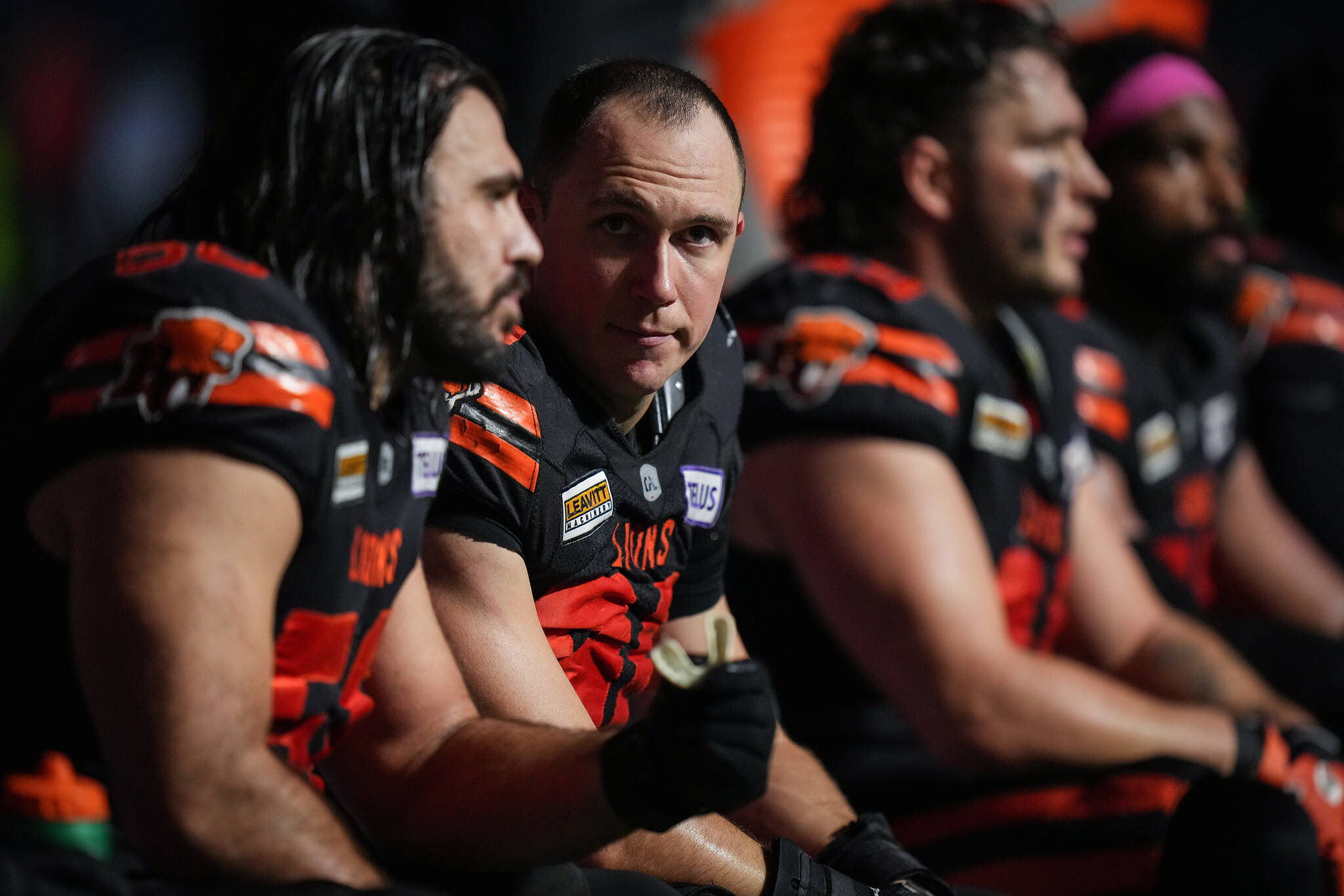 B.C. Lions defensive lineman Mathieu Betts, second left, talks with David Menard, left, as they sit on the bench after the third quarter of a CFL football game against the Calgary Stampeders, in Vancouver, on Friday, October 20, 2023. Betts recorded his 18th sack of the season to set a new single-season sack record by a Canadian. THE CANADIAN PRESS/Darryl Dyck