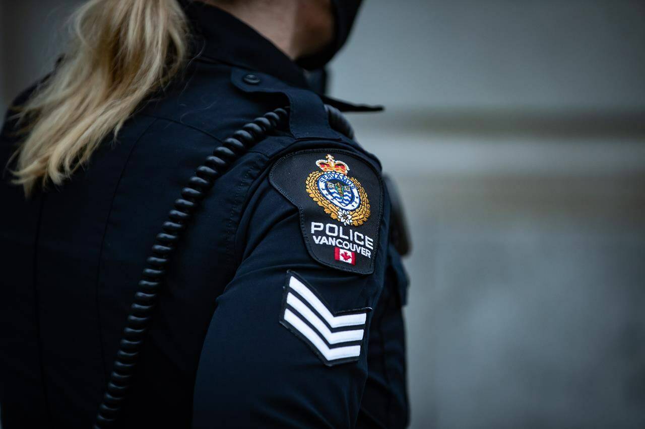 Vancouver police say two robbery suspects fled the scene in a taxi on Jan. 29, but officers arrested the pair shortly after. A Vancouver Police Department patch is seen on an officer’s uniform during a call in Vancouver, B.C., Saturday, Jan. 9, 2021. THE CANADIAN PRESS/Darryl Dyck