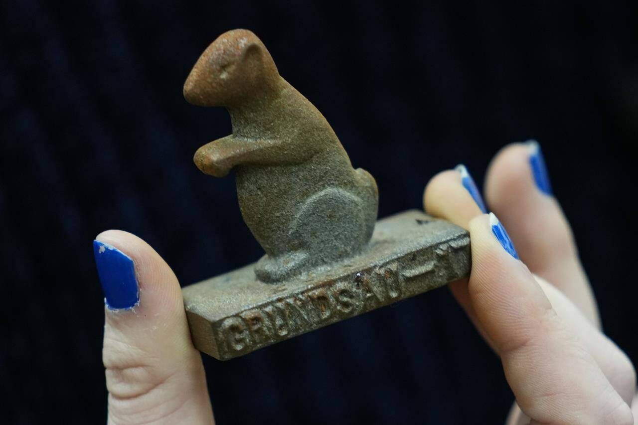 Anthropologist Sarah Edris with the Pennsylvania German Cultural Heritage Center holds a commemorative keepsake during an interview in Kutztown, Pa., Monday, Jan. 29, 2024. These lodges began as a way to preserve and celebrate Pennsylvania Dutch culture and traditions. (AP Photo/Matt Rourke)