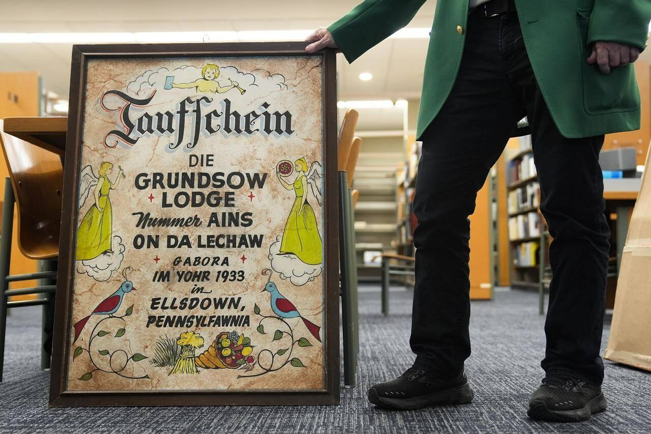 Kutztown University anthropology professor William W. Donner displays a Groundhog Lodge’s birth certificate during an interview in Kutztown, Pa., Monday, Jan. 29, 2024. These lodges began as a way to preserve and celebrate Pennsylvania Dutch culture and traditions. (AP Photo/Matt Rourke)