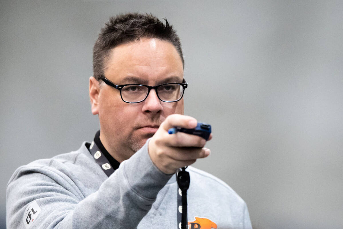 Neil McEvoy holds a stopwatch during a training and scouting session. (Photo courtesy of the BC Lions)