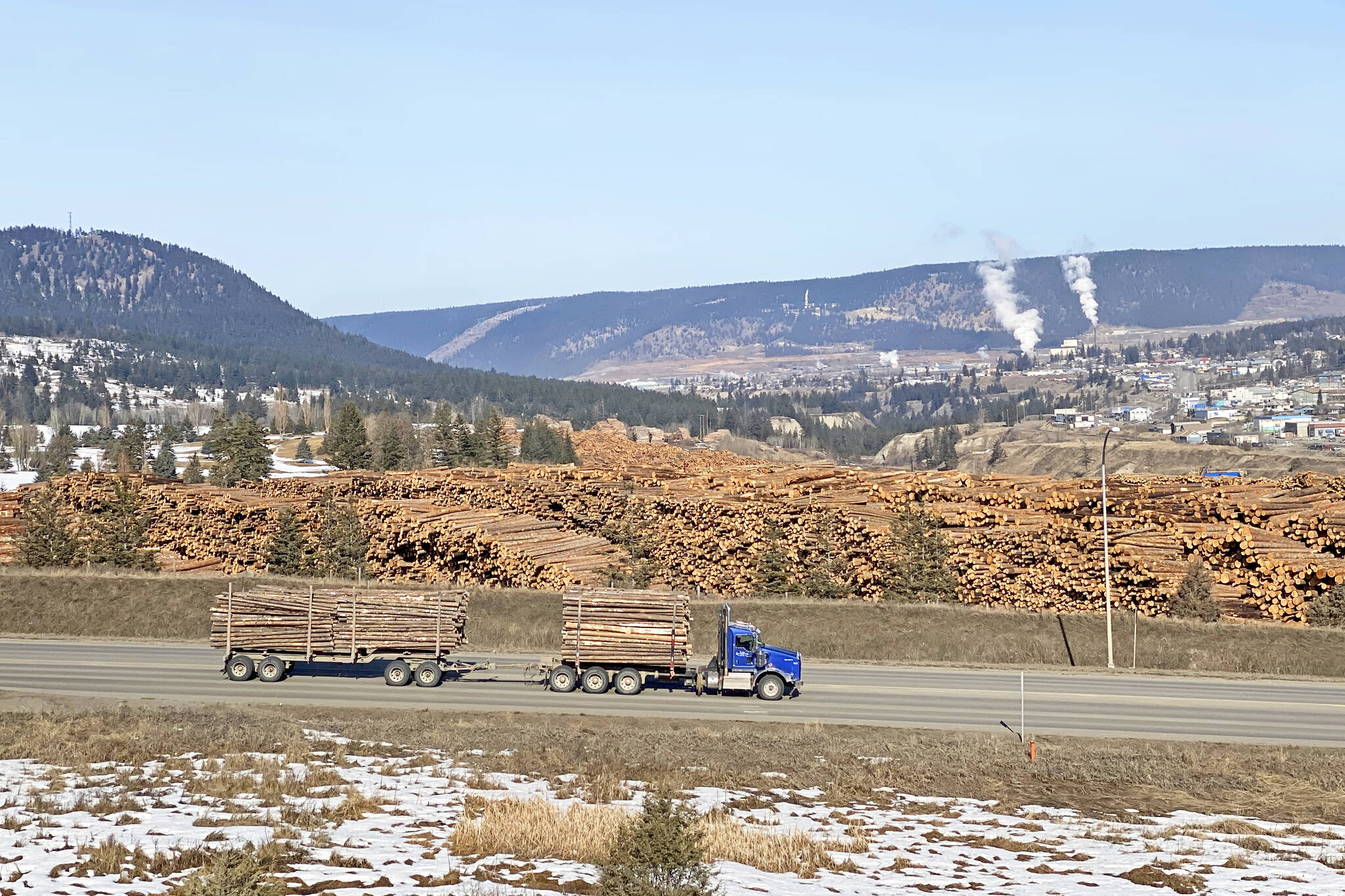 A truck loaded with logs travels down Highway 20 past the Tolko Industries Ltd. Lakeview Division log yard during the second week in March 2023. (Angie Mindus photo - Williams Lake Tribune)