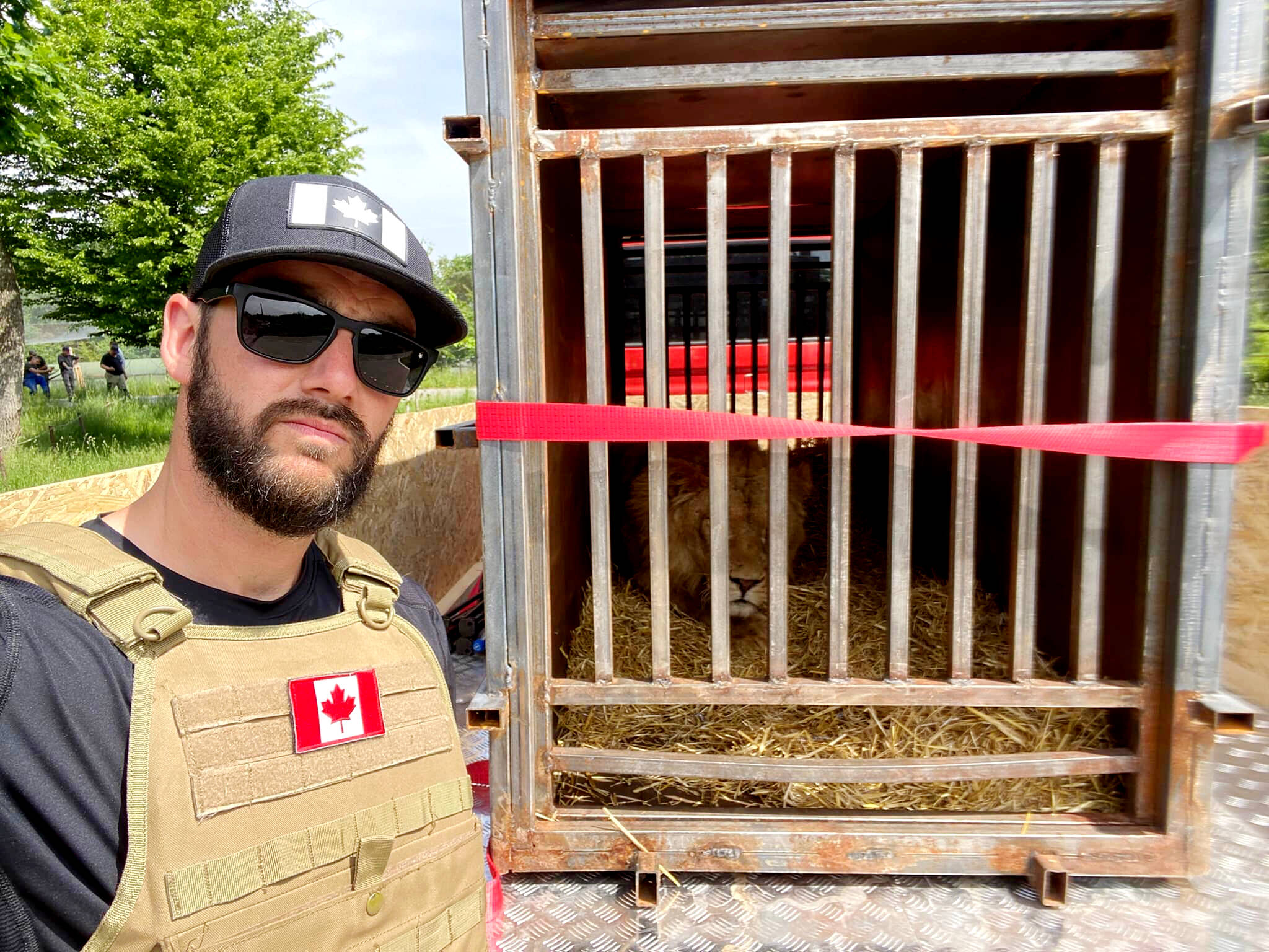 Raincoast Dog Rescue Society founder, Jesse Adams, stands outside a lion’s cage, as he helps rescue nine African lions from a conflict-ridden zoo in Ukraine. (Contributed photo)