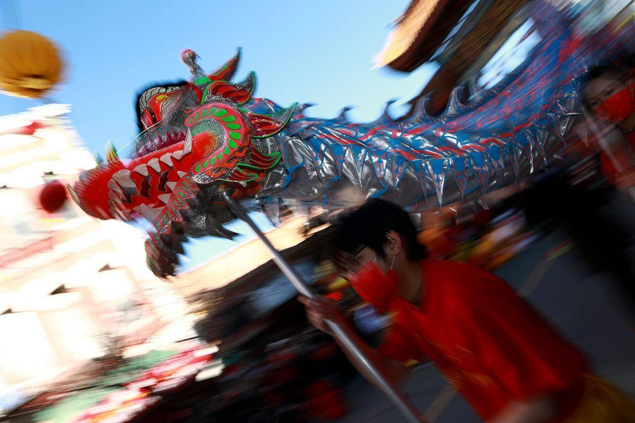 Progressive and LGBTQ+ groups say they’ve been excluded from Vancouver’s Lunar New Year parade in Chinatown, with one organizer saying they were ousted for “political affiliations.” Performers carry a dragon as people gather to celebrate Lunar New Year celebrations in Victoria, B.C., Sunday, Jan. 29, 2023. THE CANADIAN PRESS/Chad Hipolito