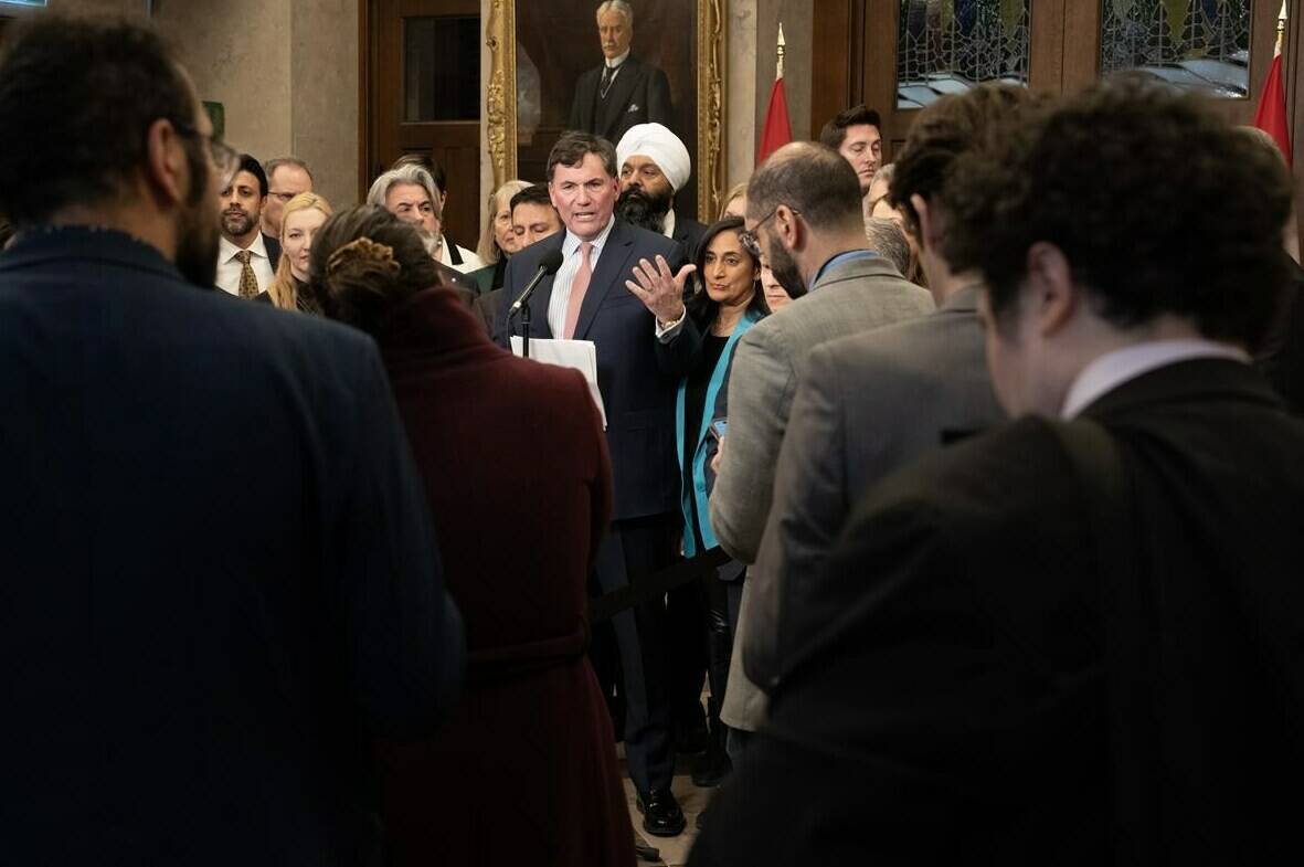 Reporters, staffers and Members of Parliament listen to Minister of Public Safety, Democratic Institutions and Intergovernmental Affairs Dominic LeBlanc speak about auto theft, Wednesday, February 7, 2024 in Ottawa. The federal government says an estimated 90,000 cars are stolen annually in Canada, resulting in about $1 billion in costs to Canadian insurance policy-holders and taxpayers. THE CANADIAN PRESS/Adrian Wyld