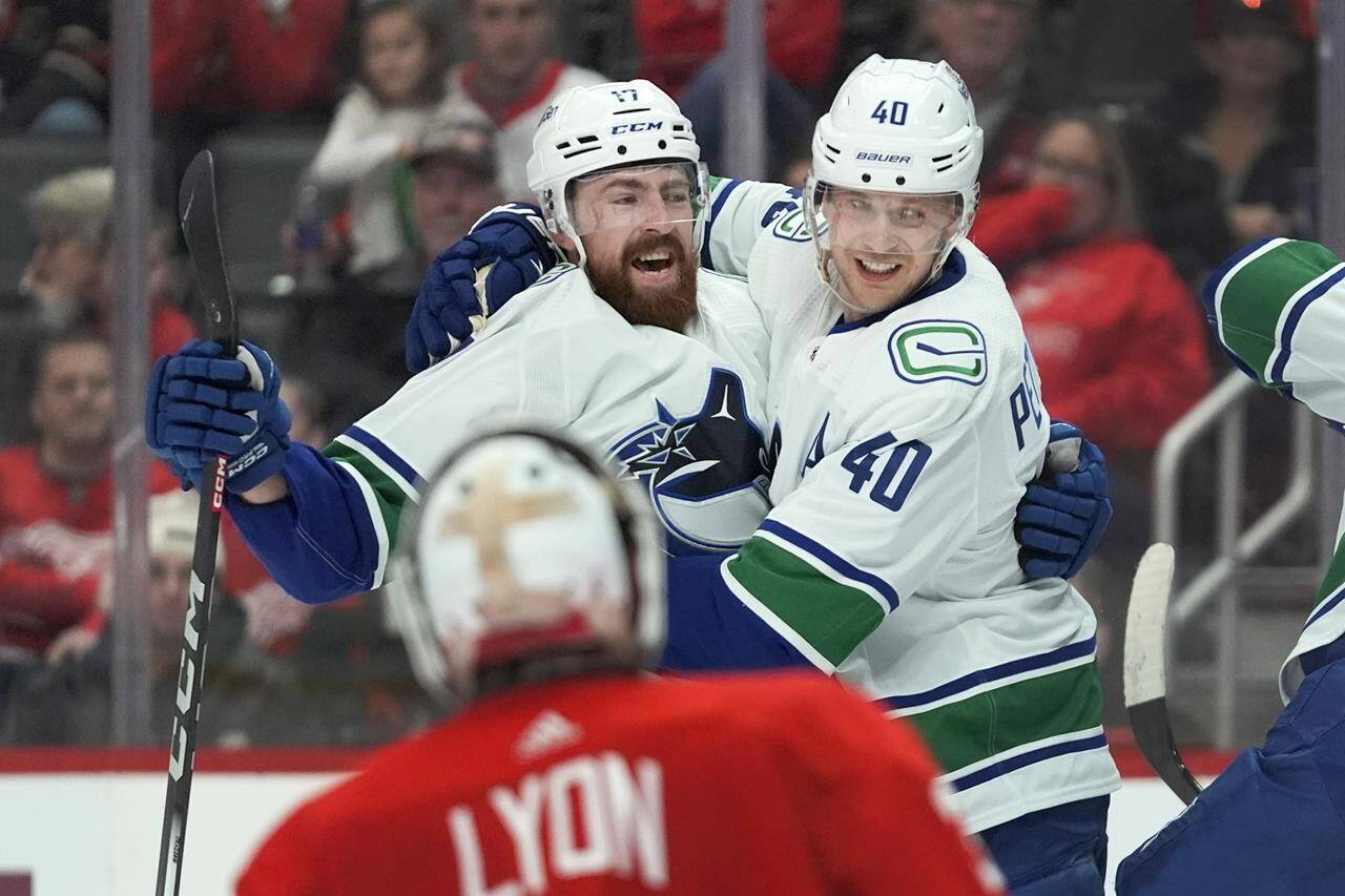 Vancouver Canucks centre Elias Pettersson (40) celebrates his goal with Filip Hronek (17) against the Detroit Red Wings in the second period of an NHL hockey game Saturday, Feb. 10, 2024, in Detroit. (AP Photo/Paul Sancya)