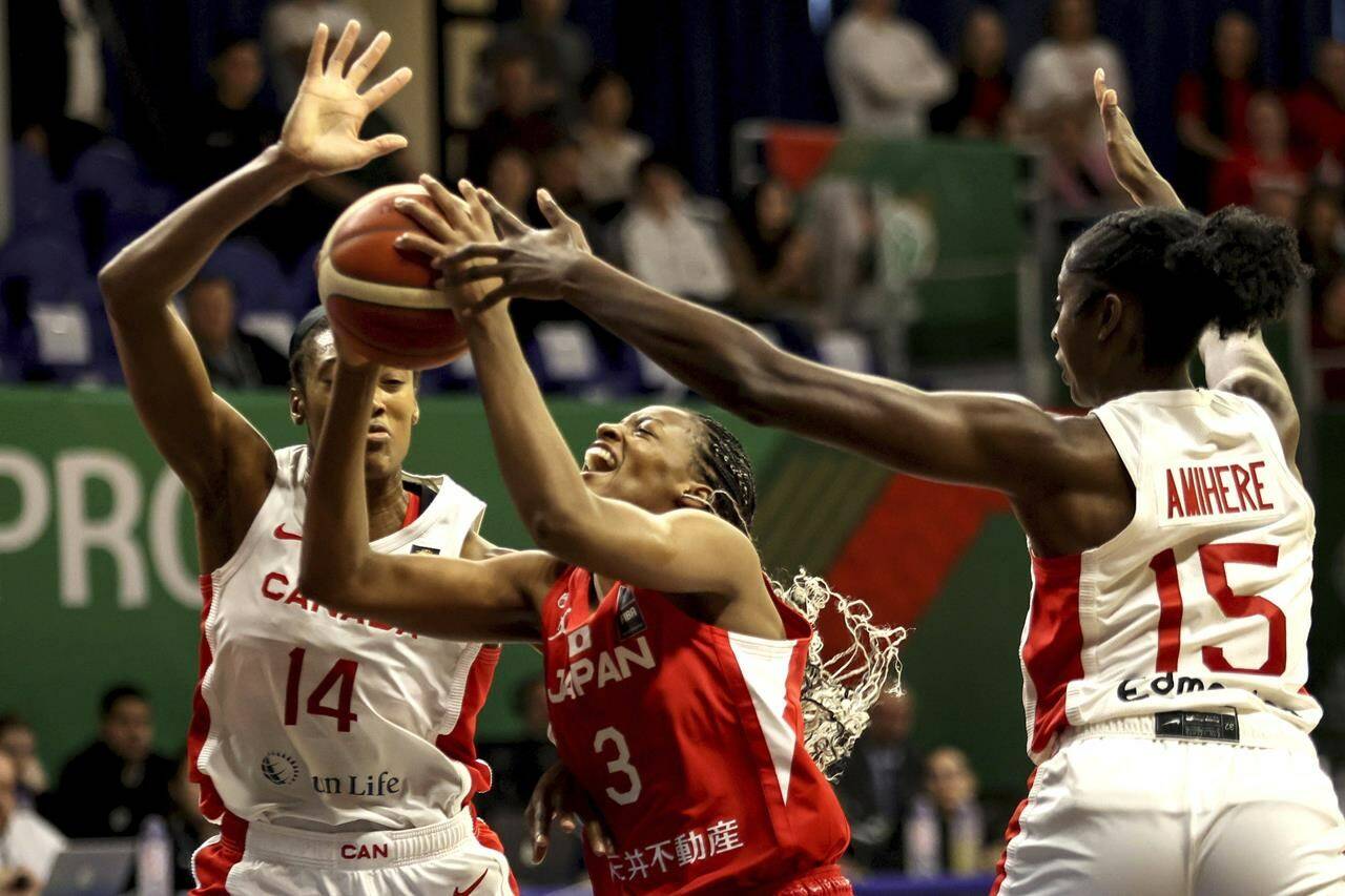 <div>Canada’s women’s basketball team will need some help to qualify for the Paris Olympics. Kayla Alexander, left, and Laeticia Amihere, right, of Canada in action against Mawuli Stephanie of Japan during the women’ basketball Olympic qualifying tournament third round match between Canada and Japan in Sopron, Hungary, Sunday, Feb. 11, 2024. THE CANADIAN PRESS/AP-MTI, Zsombor Toth</div>