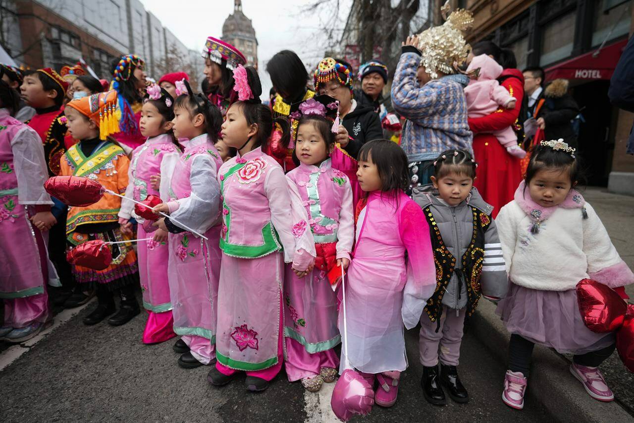 Young girls wait to participate in the Lunar New Year parade, in Vancouver, on Sunday, January 22, 2023. THE CANADIAN PRESS/Darryl Dyck