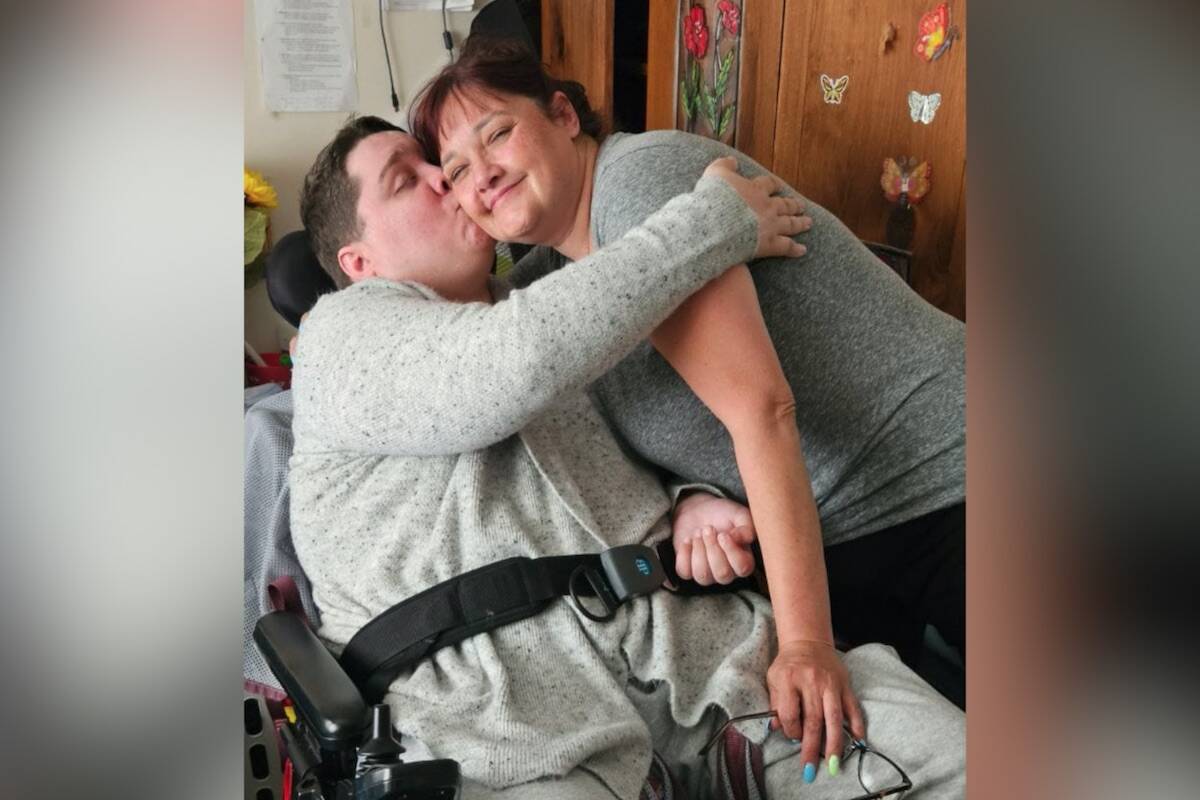 Jessie Simpson embraces his mom Sue. He was left with brain damage and in a wheelchair after being attacked with a baseball bat in 2016. (Sue Simpson)