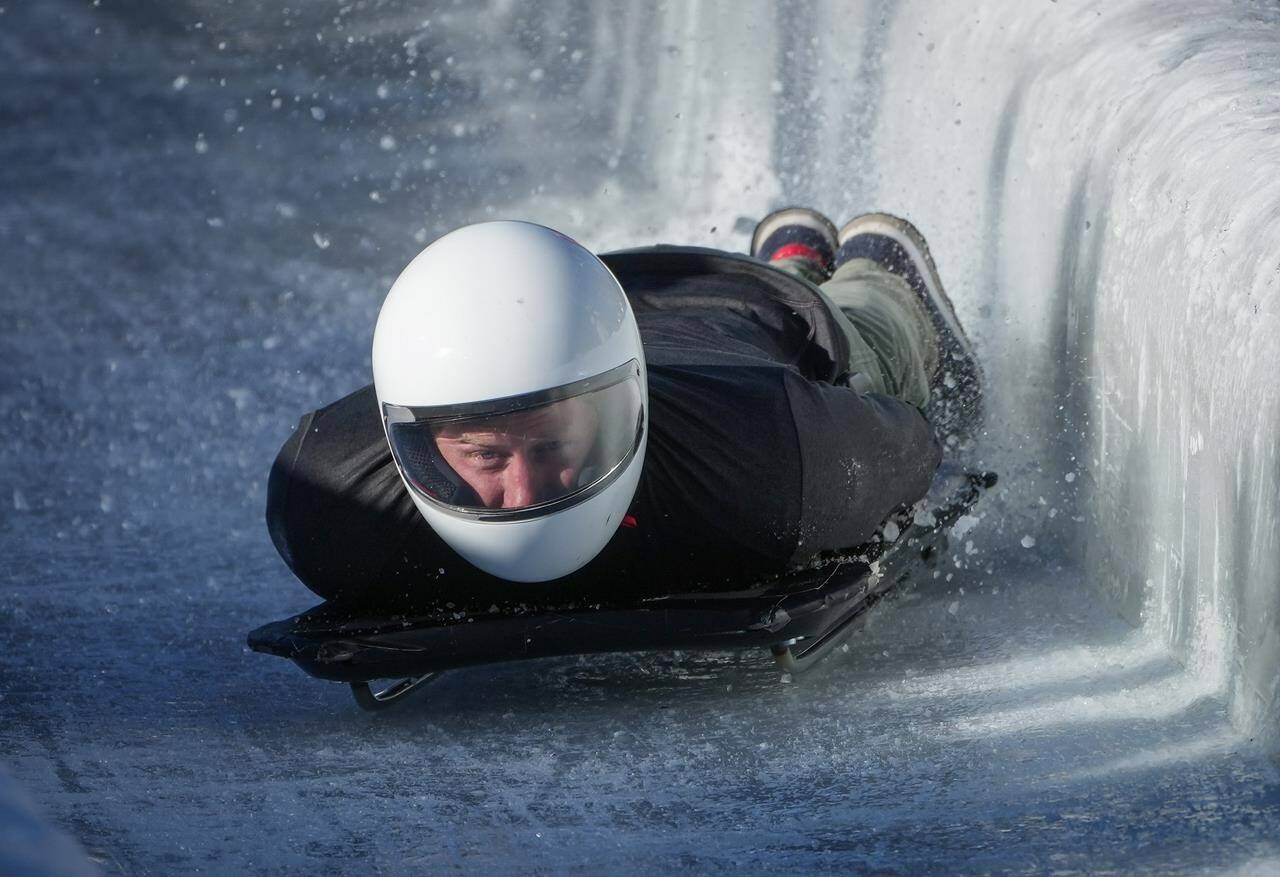Prince Harry, the Duke of Sussex, slides down the track on a skeleton sled during an Invictus Games training camp, in Whistler, B.C., Thursday, Feb. 15, 2024. Invictus Games Vancouver Whistler 2025 is scheduled to take place from Feb. 8 to 16, 2025, and will for the first time feature winter sports. THE CANADIAN PRESS/Darryl Dyck