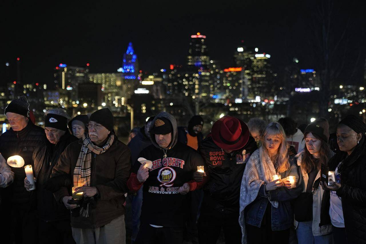People attend a candlelight vigil for victims of a shooting at a Kansas City Chiefs Super Bowl victory rally Thursday, Feb. 15, 2024 in Kansas City, Mo. More than 20 people were injured and one woman killed in the shooting near the end of Wednesday’s rally held at nearby Union Station. (AP Photo/Charlie Riedel)