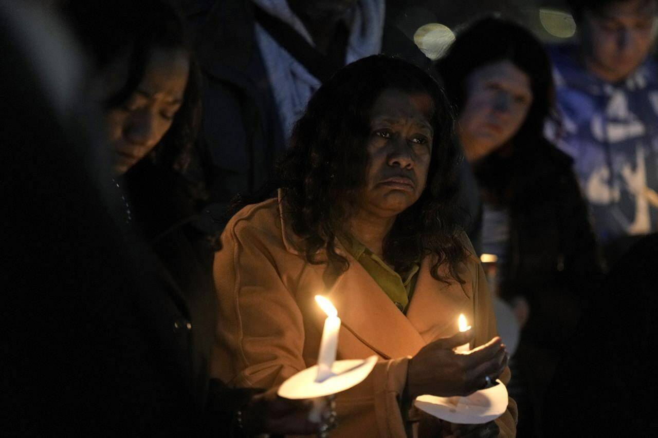 People attend a candlelight vigil for victims of a shooting at a Kansas City Chiefs Super Bowl victory rally Thursday, Feb. 15, 2024 in Kansas City, Mo. More than 20 people were injured and one woman killed in the shooting near the end of Wednesday’s rally held at nearby Union Station. (AP Photo/Charlie Riedel)