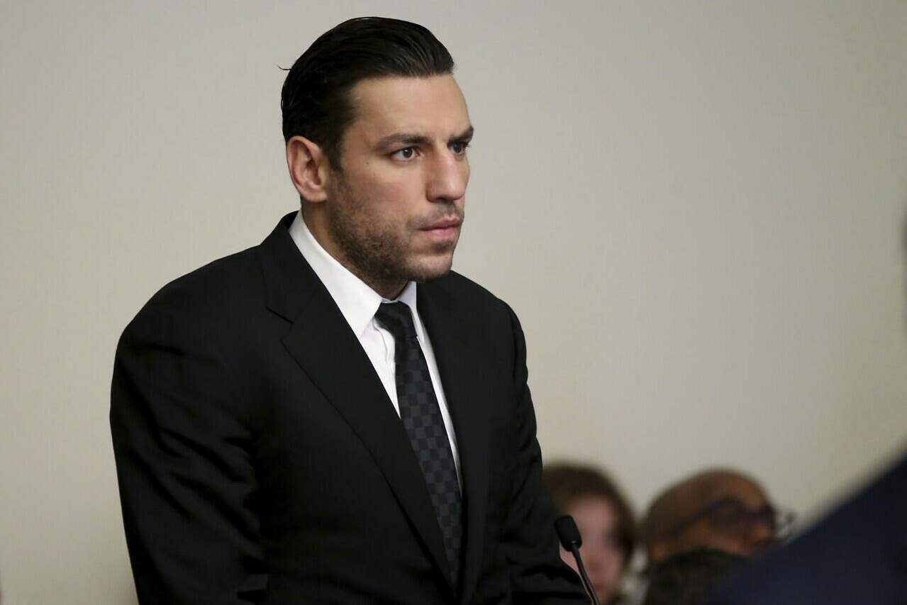 FILE - Boston Bruins forward Milan Lucic stands during his arraignment Tuesday, Nov. 21, 2023, in Boston Municipal Court, in Boston, on an assault charge in connection with his arrest over the weekend after his wife called police to their home and said he tried to choke her. Prosecutors dropped a domestic violence charge against Boston Bruins forward Milan Lucic on Friday, Feb. 16, 2024, saying the decision by his wife to invoke marital privilege made it impossible for them to prove their case beyond a reasonable doubt.(Jonathan Wiggs/The Boston Globe via AP, Pool, File)