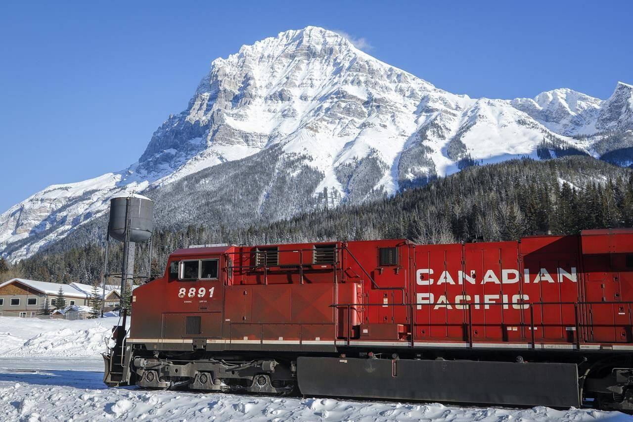 An eastbound Canadian Pacific Railway train waits in Field, B.C., for the line to be cleared, on Monday, Feb. 4, 2019. Canadian Pacific Railway Ltd. says it has completed its acquisition of Kansas City Southern and placed shares of the U.S. railway in a voting trust while the U.S. Surface Transportation Board reviews the deal.THE CANADIAN PRESS/Jeff McIntosh