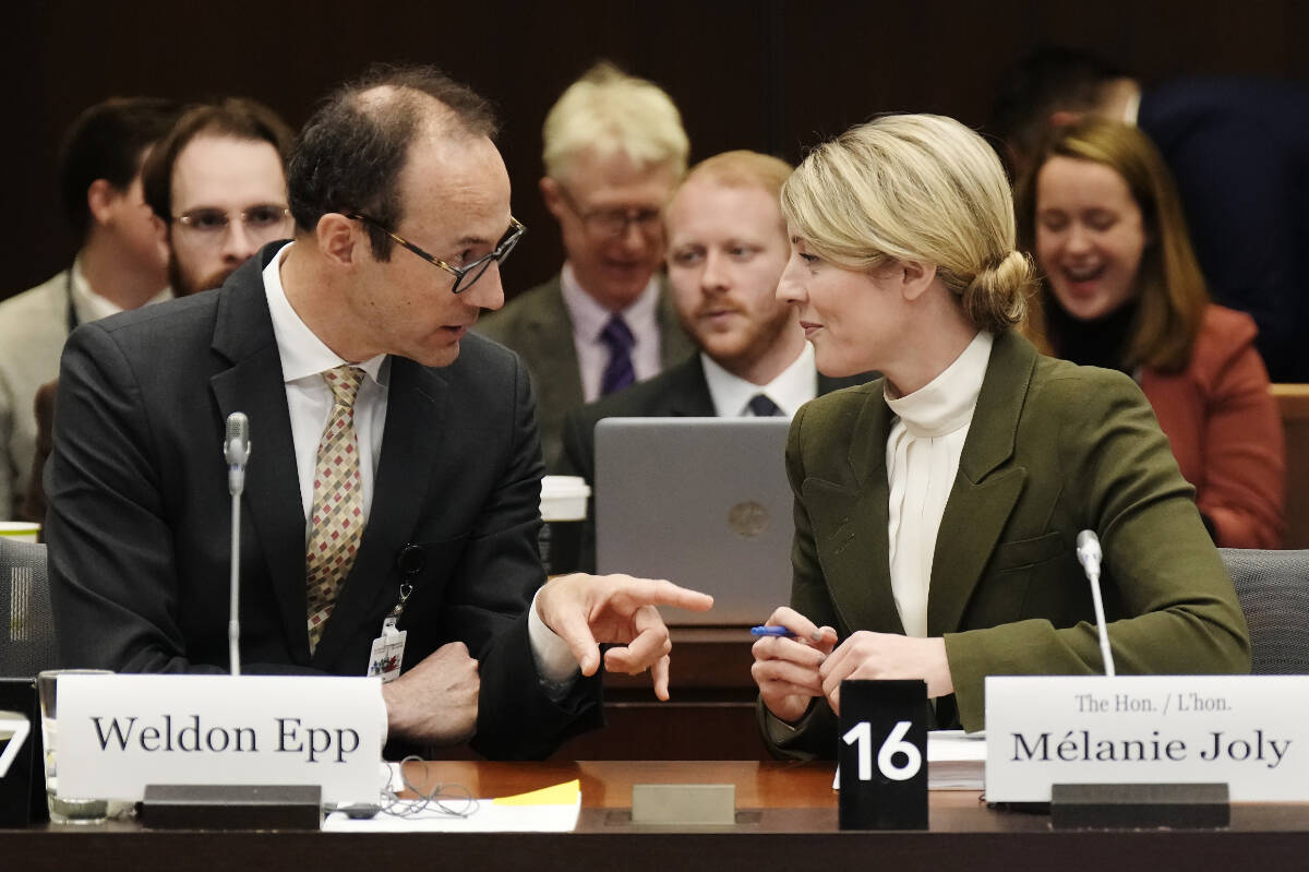 Foreign Affairs Minister Melanie Joly speaks with senior Global Affairs Canada official, Weldon Epp before appearing at committee, Wednesday, March 22, 2023 in Ottawa. THE CANADIAN PRESS/Adrian Wyld