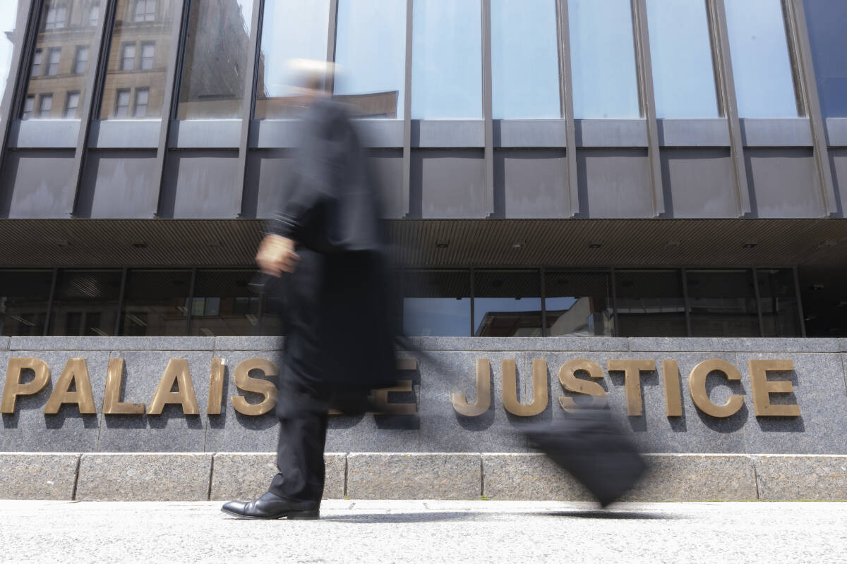A lawyer walks past the courthouse in Montreal, Wednesday, July 12, 2023. THE CANADIAN PRESS/Christinne Muschi