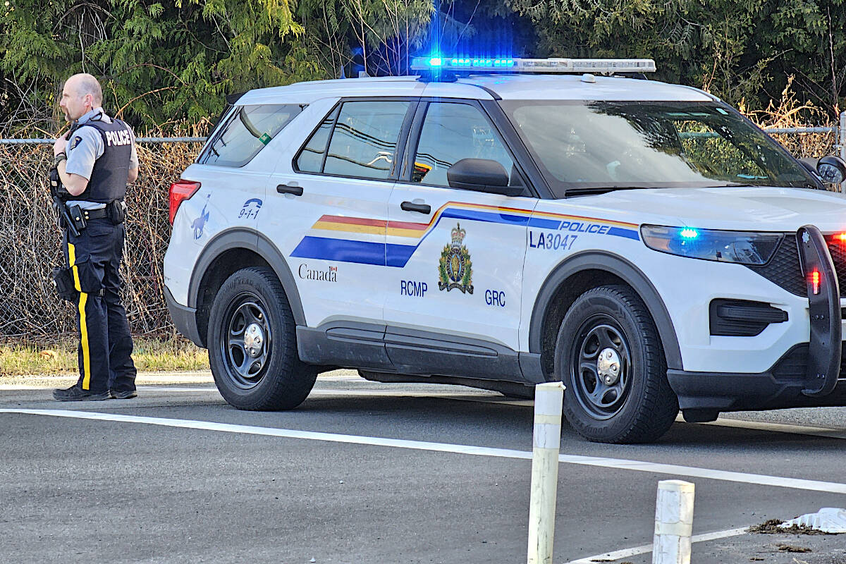 A Langley RCMP officer redirected traffic after a crash on 16th Avenue between 240th and 248th Street closed that section of the route to traffic for about eight hours on Monday, Family Day, Feb. 19. (Dan Ferguson/Langley Advance Times)