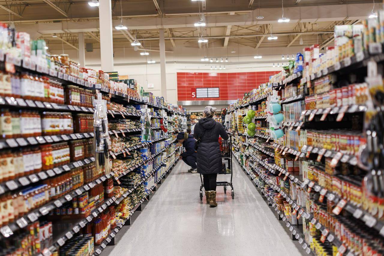 Statistics Canada is set to release its January consumer price index report this morning. A shopper browses in an aisle at a grocery store In Toronto on Friday, Feb. 2, 2024. THE CANADIAN PRESS/Cole Burston