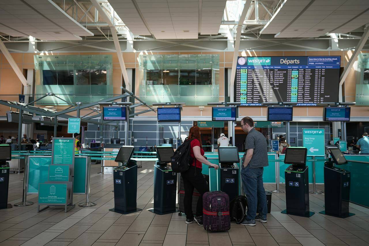 <div>Statistics Canada says the price of airfare fell more than 14 per cent in January versus the same month in 2023. WestJet passengers use a self-service kiosk in the domestic check-in area at Vancouver International Airport, in Richmond, B.C., on Friday, May 19, 2023. THE CANADIAN PRESS/Darryl Dyck</div>