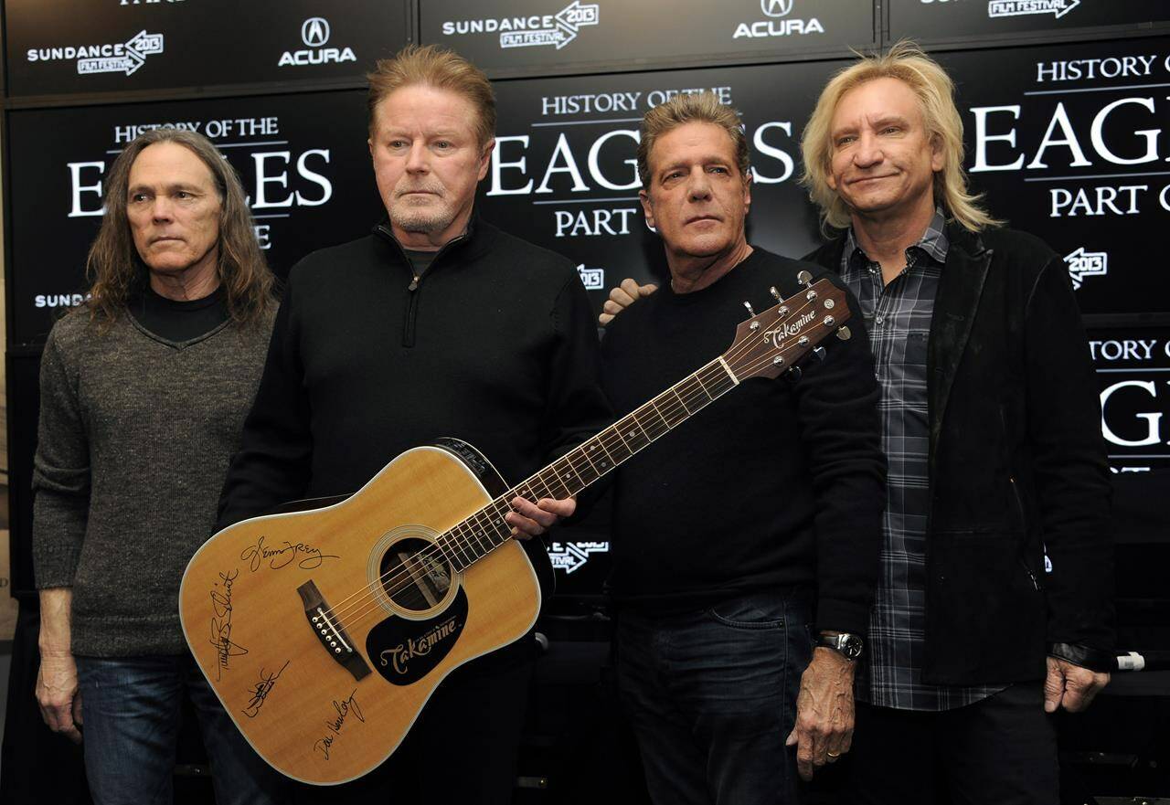 FILE - Members of The Eagles, from left, Timothy B. Schmit, Don Henley, Glenn Frey and Joe Walsh pose with an autographed guitar after a news conference at the Sundance Film Festival, Jan. 19, 2013, in Park City, Utah. On Wednesday, Feb. 21, 2024, an unusual criminal trial is set to open over the handwritten lyrics to the band’s classic rock blockbuster’ “Hotel California.” (Photo by Chris Pizzello/Invision/AP, File)