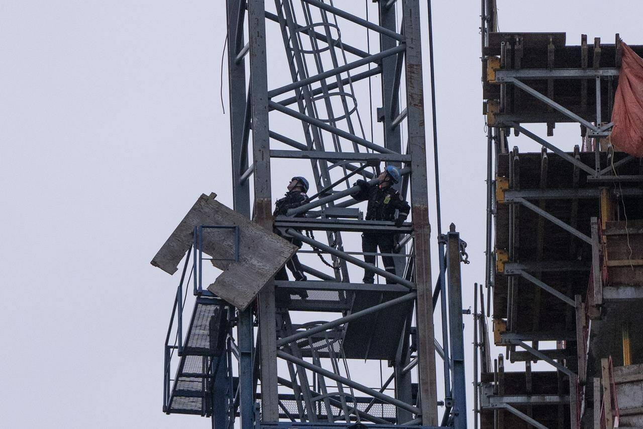 The mayor of Vancouver says he is “deeply saddened” by the death of a worker in Vancouver’s Oakridge neighbourhood when a load from a crane fell on a building under construction. Vancouver Fire and Rescue Services workers climb to retrieve loose building materials after a load from a crane fell from the top of the building smashing multiple floors of the Oakridge Mall construction in Vancouver, B.C., Wednesday, Feb. 21, 2024. THE CANADIAN PRESS/Ethan Cairns.