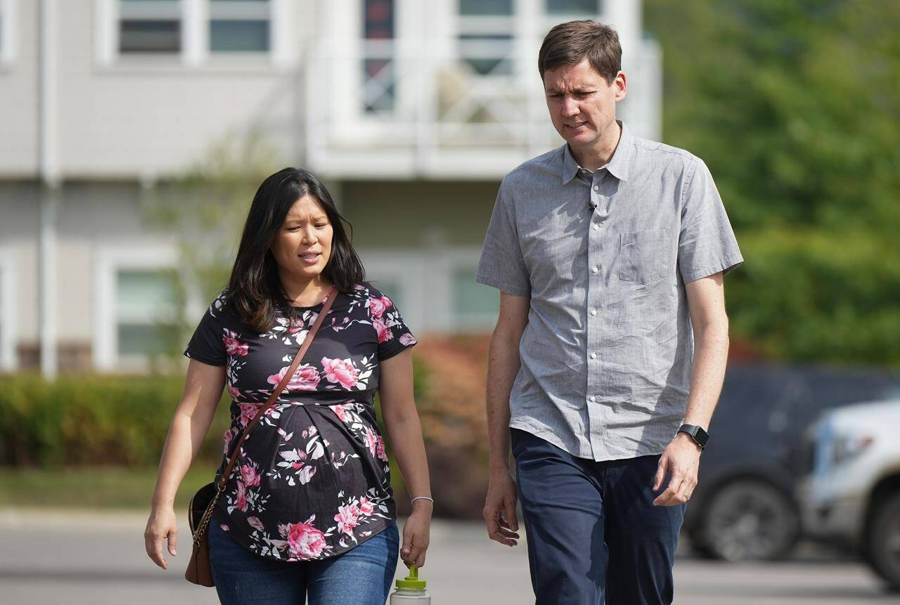 Minister of Emergency Management and Climate Readiness Bowinn Ma, left, and B.C. Premier David Eby walk together as they arrive for a meeting at the Columbia Shuswap Regional District offices, in Salmon Arm, B.C., Monday, Sept. 11, 2023. (THE CANADIAN PRESS/Darryl Dyck)