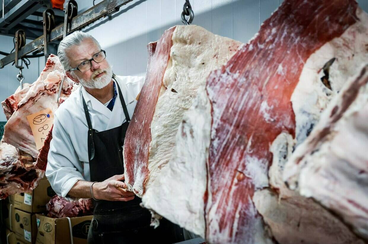 Butcher John Wildenborg works in his independent meat shop in Calgary, Wednesday, Feb. 14, 2024. THE CANADIAN PRESS/Jeff McIntosh