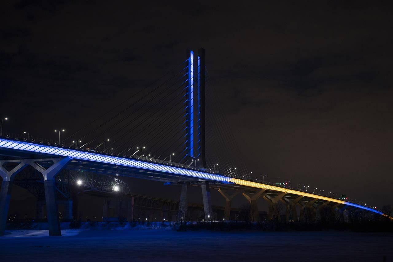The Samuel de Champlain Bridge is shown lit up in the colours of Ukraine in Montreal, Saturday, February 26, 2022, in a show of support from the government of Canada for the Ukrainian people and all Ukrainian Canadians. THE CANADIAN PRESS/Graham Hughes