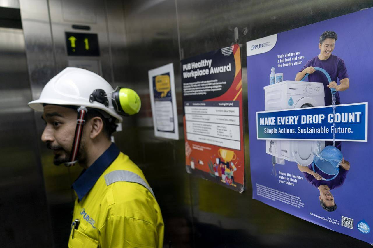 A poster promoting water conservation is posted in an elevator at the Changi Water Reclamation Plant in Singapore, Thursday, July 20, 2023. Water technology developed and used in Singapore, such as portable water filters, water testing technology and flood management tools, have been exported to over 30 countries, including Indonesia, Malaysia and Nepal. (AP Photo/David Goldman)