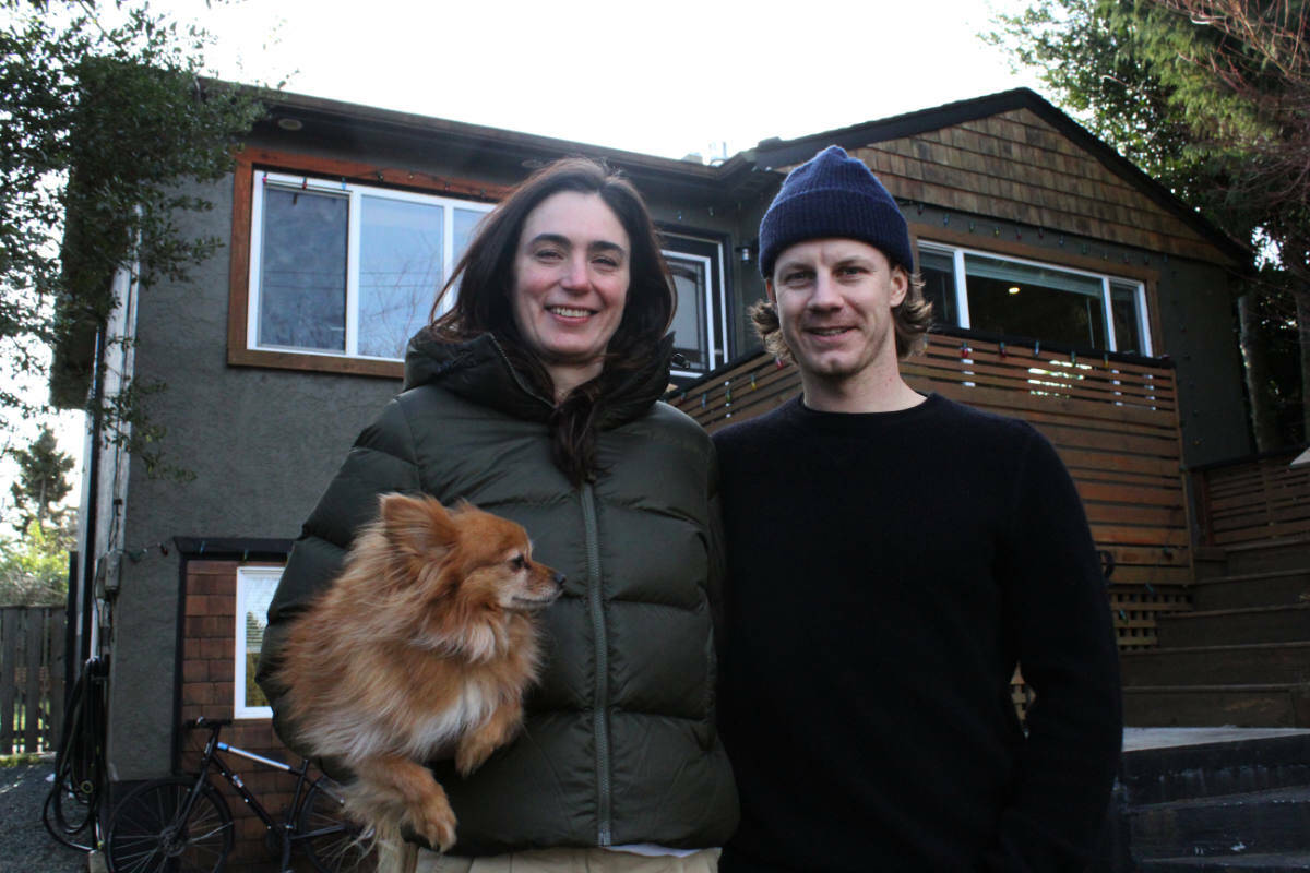 Mica Munro and Jasper Smith pose in front of their Saanich home they bought two years. (Ella Matte/News Staff)