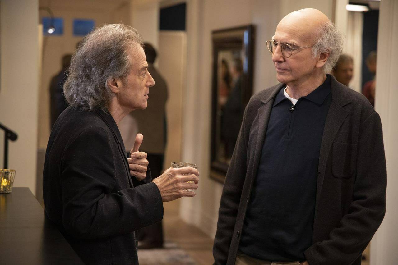 This image released by HBO shows Richard Lewis, left, with Larry David in a scene from Season 10 of “Curb Your Enthusiasm.” Lewis, an acclaimed comedian known for exploring his neuroses in frantic, stream-of-consciousness diatribes while dressed in all-black, leading to his nickname “The Prince of Pain,” has died. He was 76. He died at his home in Los Angeles on Tuesday night after suffering a heart attack, according to his publicist Jeff Abraham. (John P. Johnson/HBO via AP)