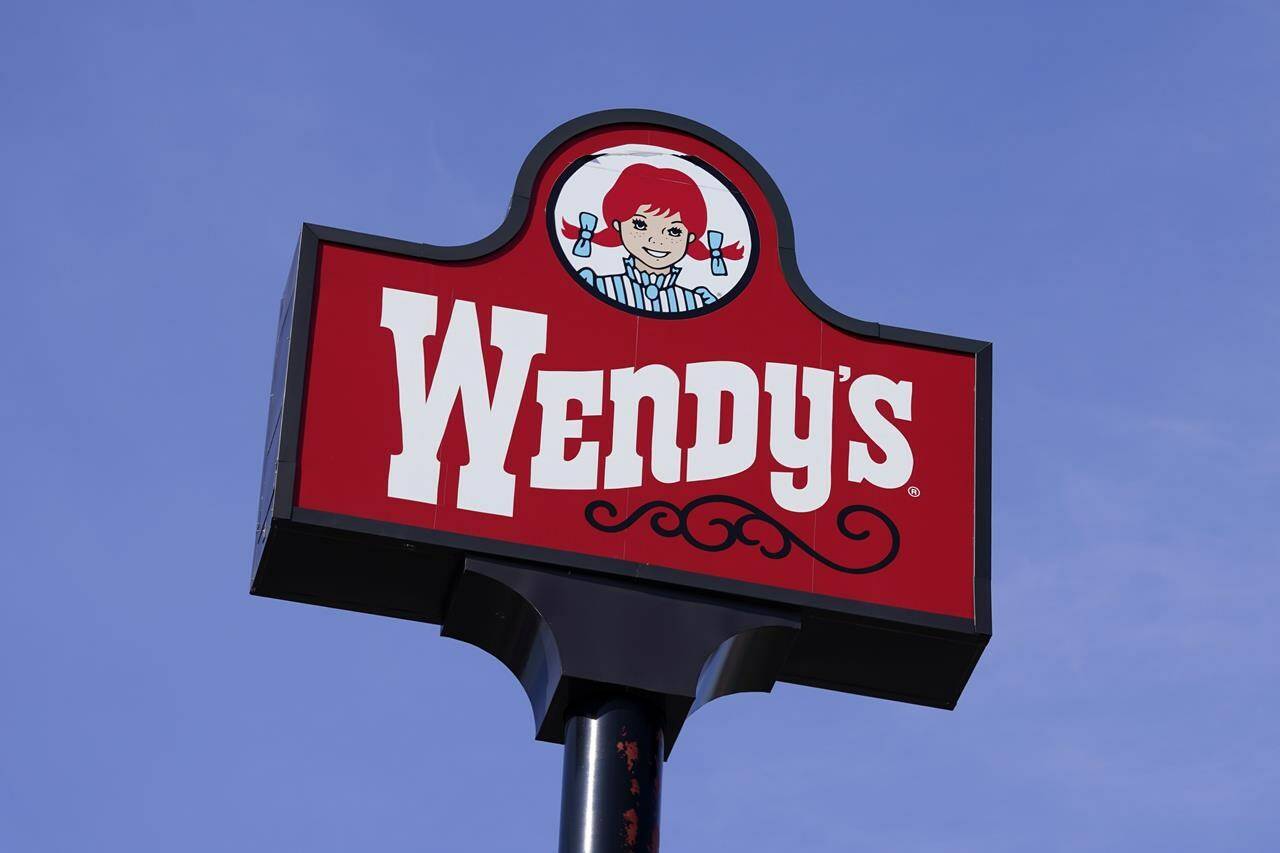 FILE - A sign stands over a Wendy’s restaurant, Feb. 25, 2021, in Des Moines, Iowa. Wendy’s says that it has no plans to increase prices during the busiest times at its restaurants, Wednesday, Feb. 28, 2024. The burger chain clarified its stance on how it will approach pricing after various media reports said that the company was looking to test having the prices of its menu items fluctuate throughout the day based on demand. (AP Photo/Charlie Neibergall, File)