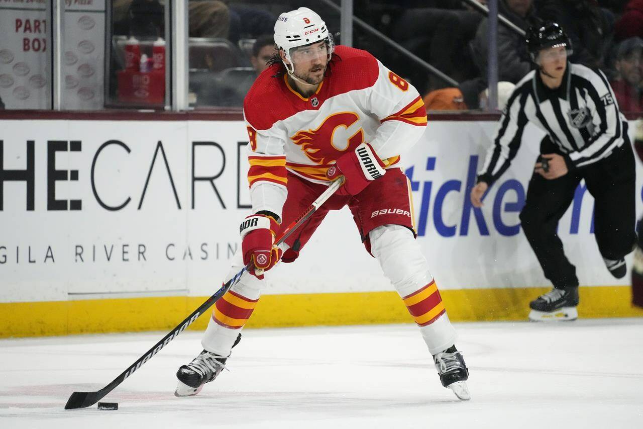 Calgary Flames defenceman Chris Tanev looks to pass the puck against the Arizona Coyotes during the second period of an NHL hockey game Thursday, Jan. 11, 2024, in Tempe, Ariz. THE CANADIAN PRESS/AP, Ross D. Franklin