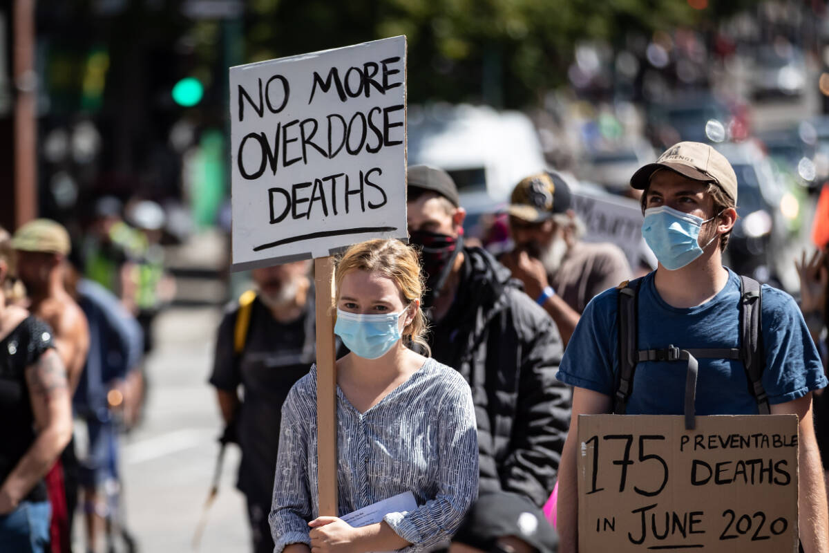 People hold signs during a memorial march to remember victims of overdose deaths in Vancouver on Saturday, August 15, 2020. BC Coroners Service says at least 198 people died of overdoses in the province in January 2024 from toxic, unregulated drugs.. THE CANADIAN PRESS/Darryl Dyck