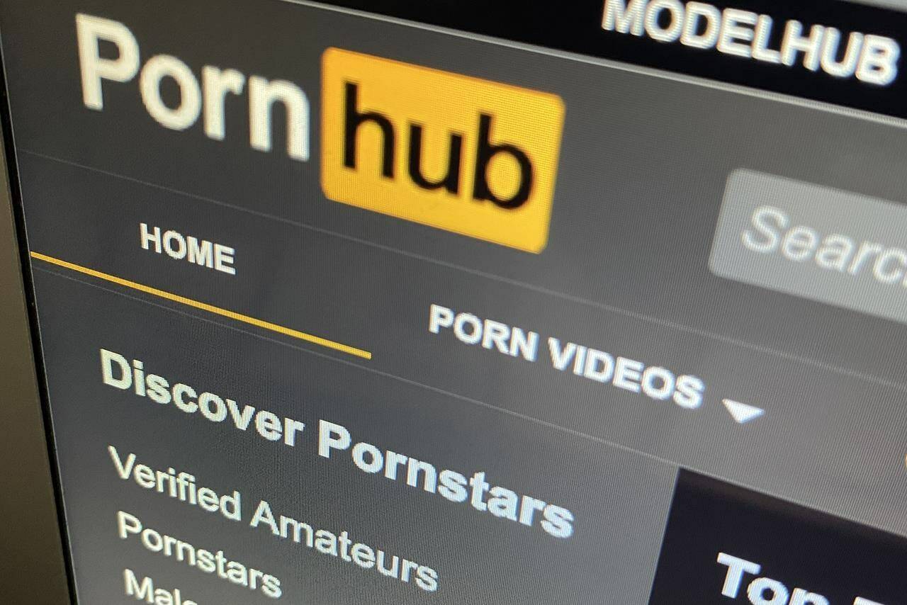 The federal privacy watchdog says the operator behind Pornhub and other pornographic sites broke the law by enabling intimate images to be shared on its websites without direct knowledge or consent. The Pornhub website is shown on a computer screen in Toronto on Wednesday, Dec. 16, 2020. THE CANADIAN PRESS