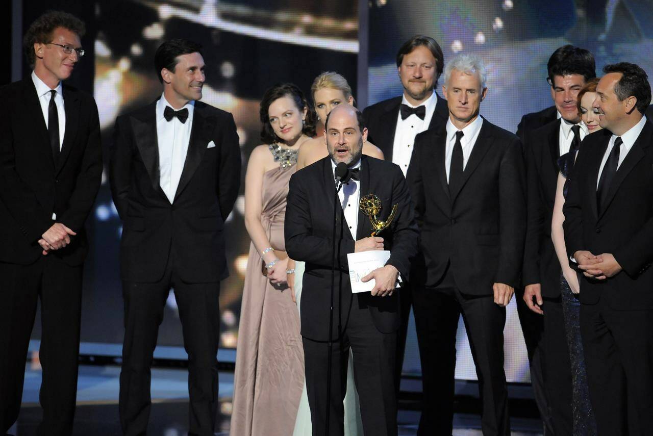 FILE - Matthew Weiner, creator of “Mad Men,” stands among cast and crew members as he accepts the award for best drama series at the 61st Primetime Emmy Awards in Los Angeles on Sept. 20, 2009. (AP Photos/Mark J. Terrill, File)