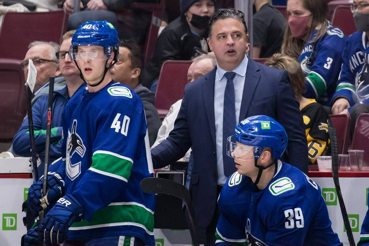 Vancouver Canucks head coach Travis Green stands on the bench during the third period of an NHL hockey game against the Pittsburgh Penguins in Vancouver, on Saturday, December 4, 2021.��The New Jersey Devils say Green has been hired as an associate coach, joining head coach Lindy Ruff’s staff. THE CANADIAN PRESS/Darryl Dyck