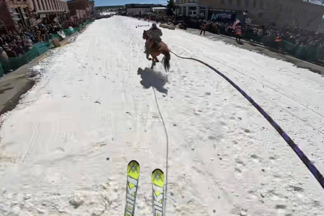 In this screengrab made from video provided by Nick Burri, a skier is pulled by a horse during a skijoring competition in Leadville, Colo., on Saturday, March 2, 2024. Skijoring draws its name from the Norwegian word skikjoring, meaning “ski driving.” It started as a practical mode of transportation in Scandinavia and became popular in the Alps around 1900. Today’s sport features horses at full gallop towing skiers by rope over jumps and around obstacles as they try to lance suspended hoops with a baton, typically a ski pole that’s cut in half. (Nick Burri, via AP)