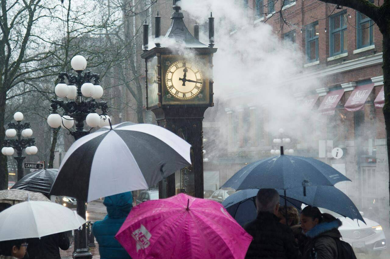 Canadians are changing their clocks tonight as much of the country prepares to spring forward for daylight time, which happens for most of the country at 2 a.m. local time. People walk by the steam clock in Gas Town in downtown Vancouver, B.C., Tuesday, Dec. 31, 2019. THE CANADIAN PRESS/Jonathan Hayward